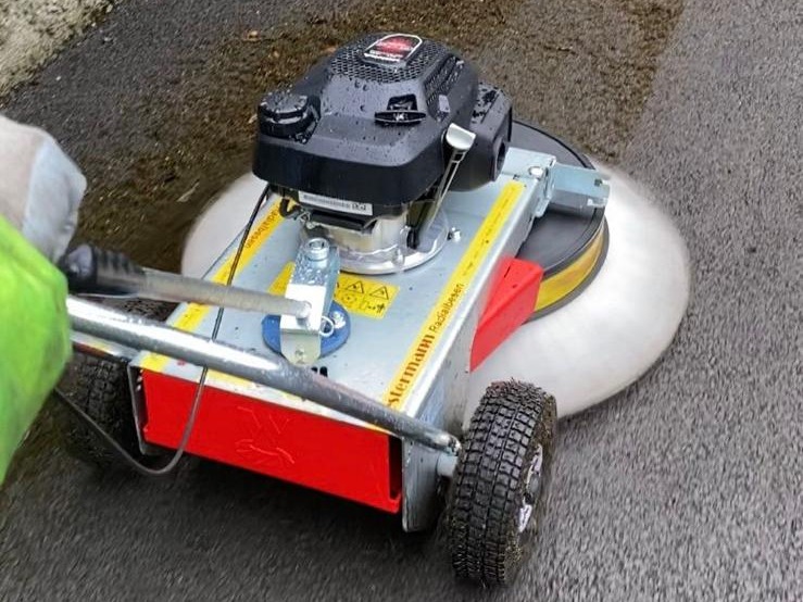 Westermann mechanical moss brush clearing moss from tarmac